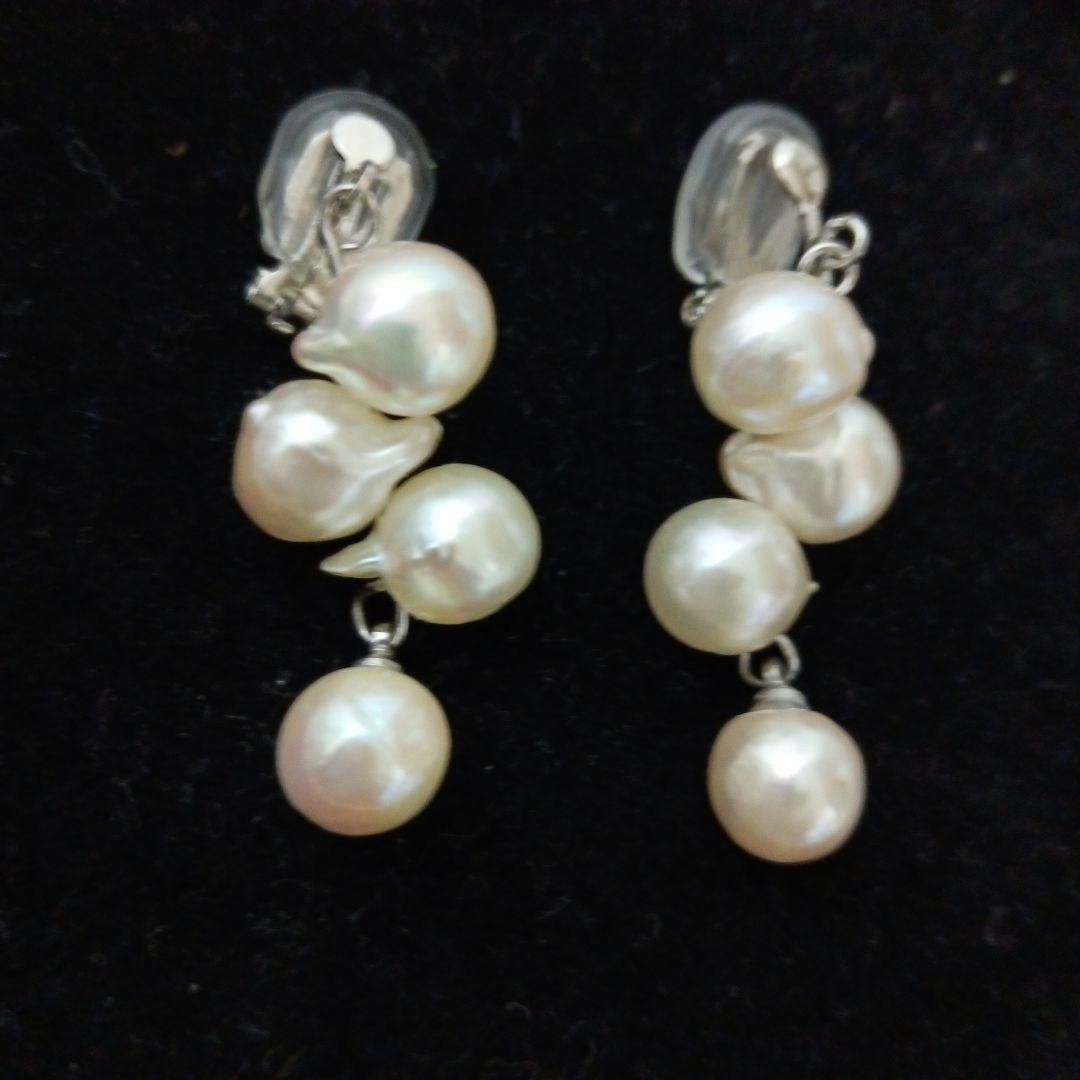 Akoya pearl necklace and earrings set with 8-9mm pearls and flower motif clasp on a white background