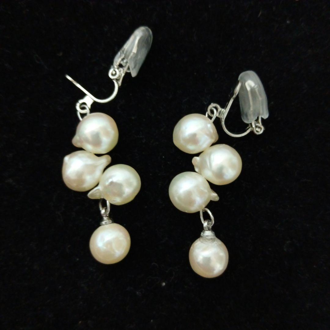 Akoya pearl necklace and earrings set with 8-9mm pearls and flower motif clasp on a white background