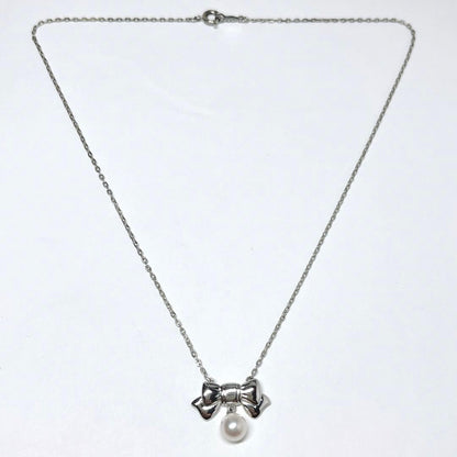 Mikimoto Akoya pearl necklace with 6.7mm pearls and silver ribbon motif pendant on 38.5cm chain