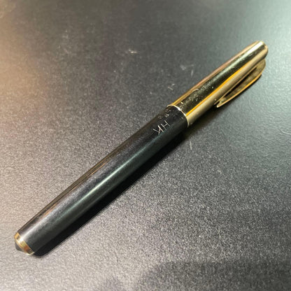 Pilot fountain pen with black and gold body featuring HK K14 engraving