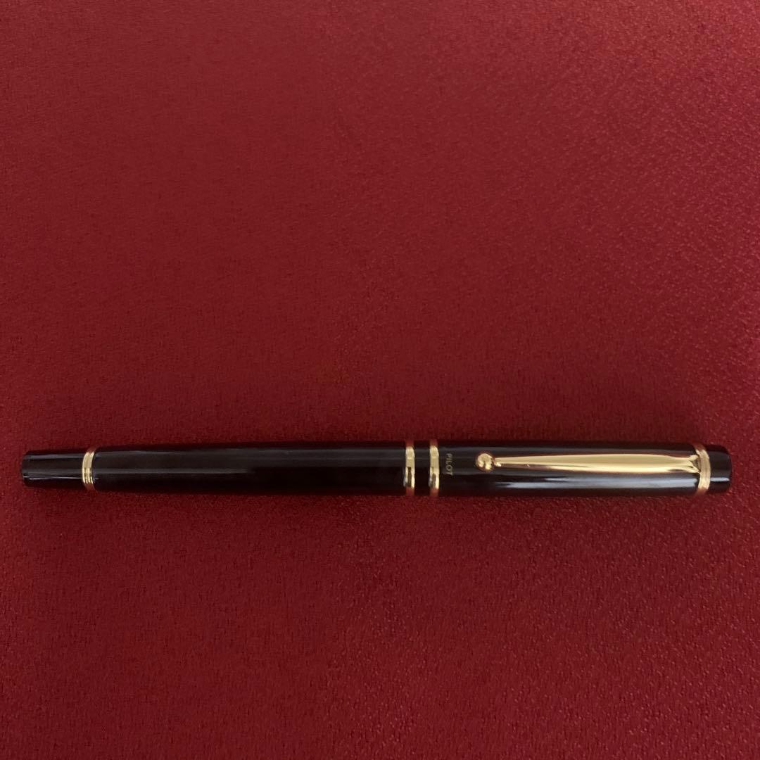 Pilot fountain pen with sleek black barrel and silver accents displayed on a white background