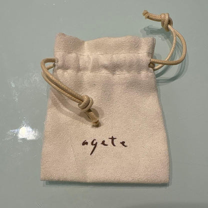 Agete necklace with chain and shell charm paired with hook earrings featuring an octagonal motif and storage pouch