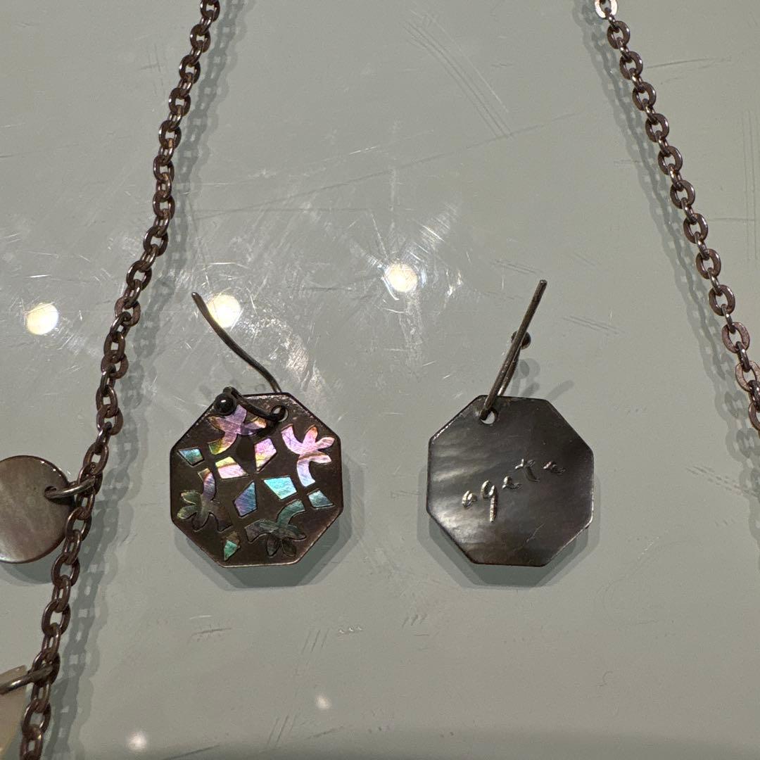 Agete necklace with chain and shell charm paired with hook earrings featuring an octagonal motif and storage pouch