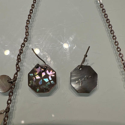 Agete necklace with chain and shell charm paired with hook earrings featuring an octagonal motif and storage pouch