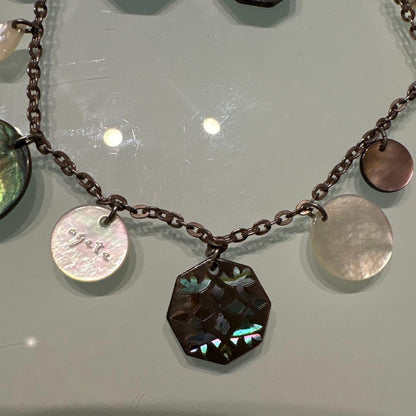 Agete necklace with chain and shell charm paired with hook earrings featuring an octagonal motif and storage pouch
