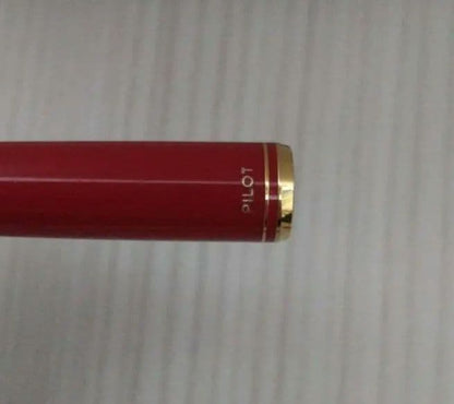 Red Pilot fountain pen with gold trim and fine tip, cartridge type, shown on white background