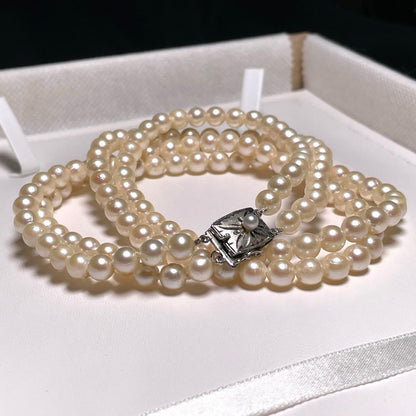 Two-row Akoya pearl necklace with 5.5-6.0mm round white pearls on silver chain model O606
