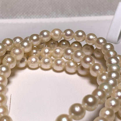 Two-row Akoya pearl necklace with 5.5-6.0mm round white pearls on silver chain model O606