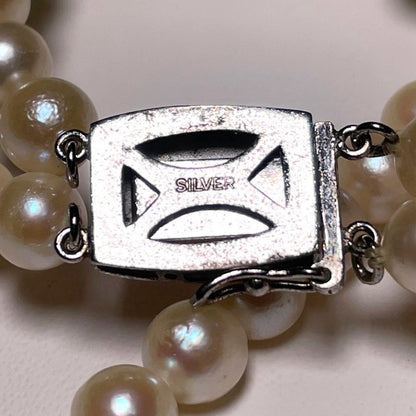Two-row Akoya pearl necklace with 5.5-6.0mm round white pearls on silver chain model O606