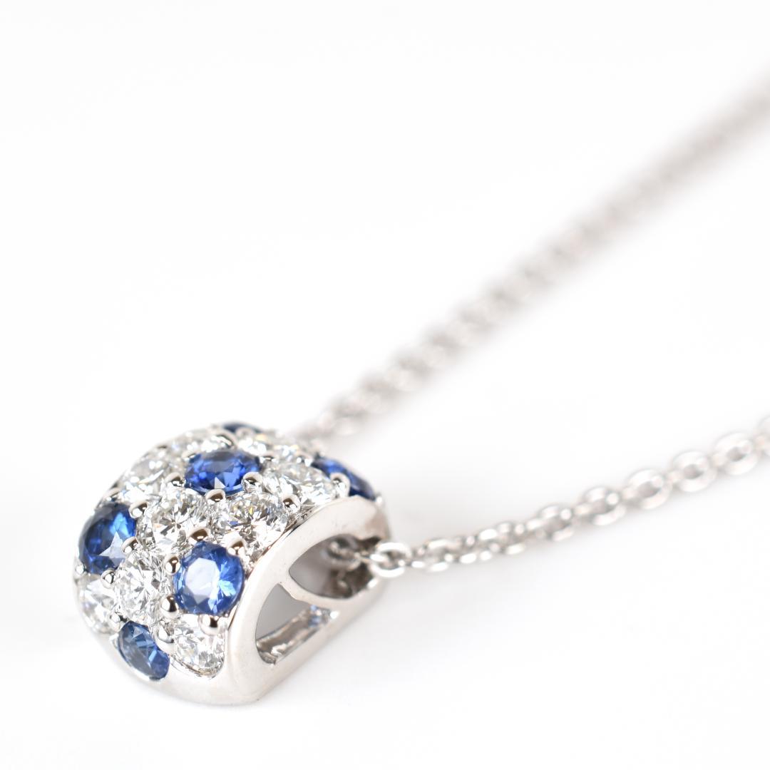 Newly restored Mikimoto white gold necklace with sapphire and diamond pendant measuring 39 cm length