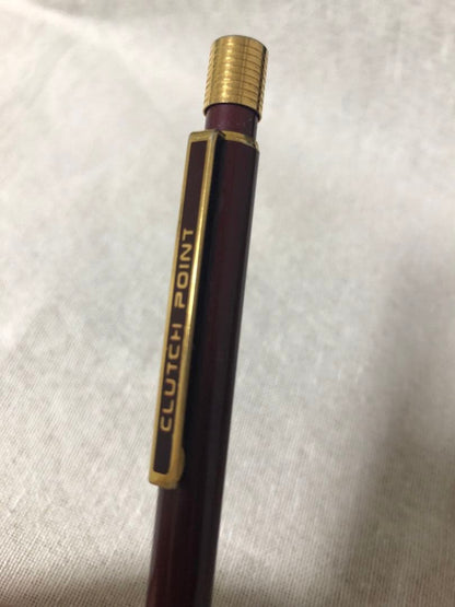 Pencil with chuck tip in reddish tone color and light rust metal parts