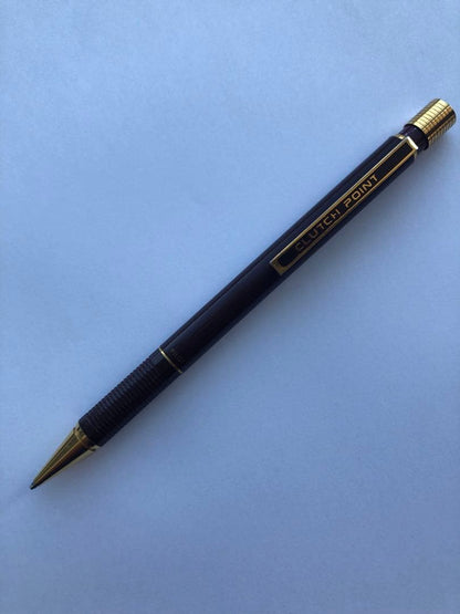 Pencil with chuck tip in reddish tone color and light rust metal parts