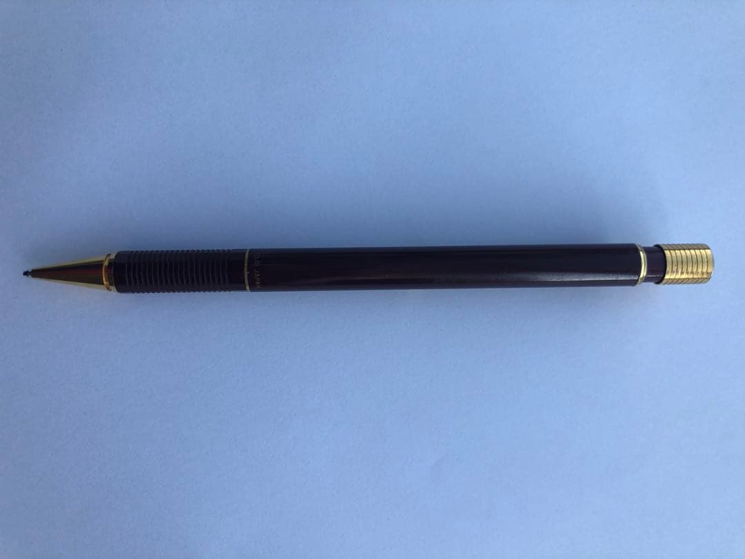 Pencil with chuck tip in reddish tone color and light rust metal parts