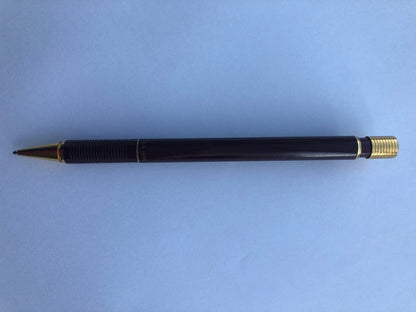 Pencil with chuck tip in reddish tone color and light rust metal parts