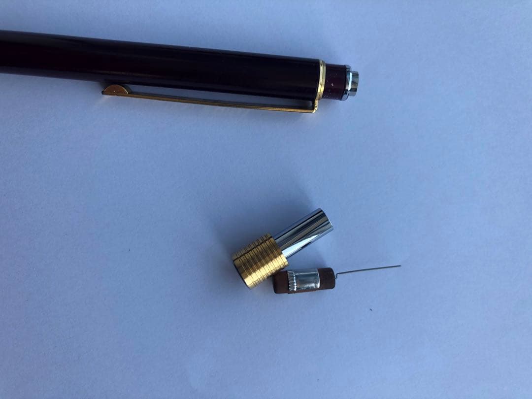 Pencil with chuck tip in reddish tone color and light rust metal parts