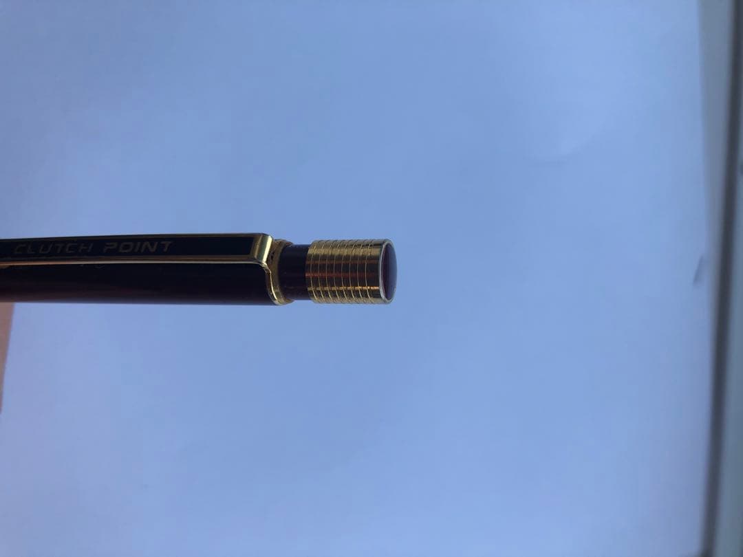 Pencil with chuck tip in reddish tone color and light rust metal parts