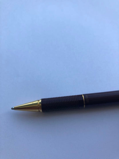 Pencil with chuck tip in reddish tone color and light rust metal parts