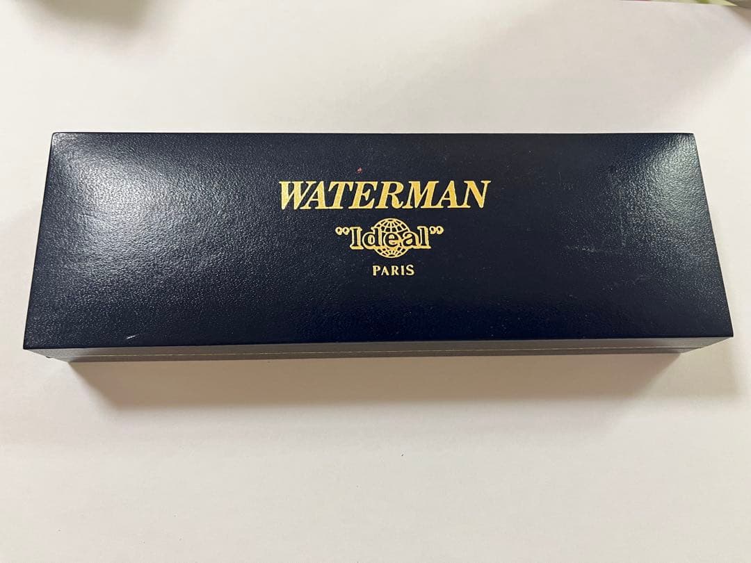 Vintage Waterman fountain pen shown with its protective case on a white background