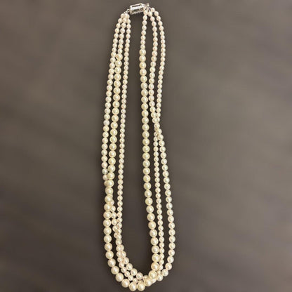 Akoya pearl necklace with three strands of varying sized white pearls, approximately 45cm long, displayed with case