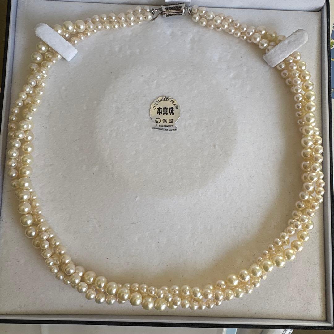 Akoya pearl necklace with three strands of varying sized white pearls, approximately 45cm long, displayed with case