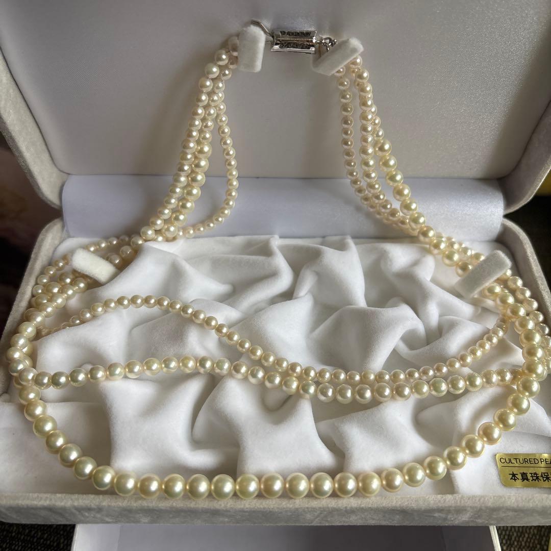 Akoya pearl necklace with three strands of varying sized white pearls, approximately 45cm long, displayed with case