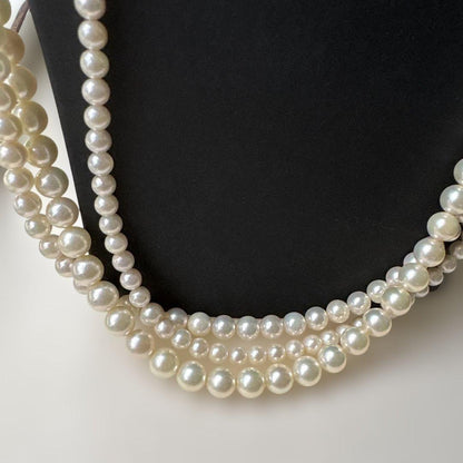 Akoya pearl necklace with three strands of varying sized white pearls, approximately 45cm long, displayed with case