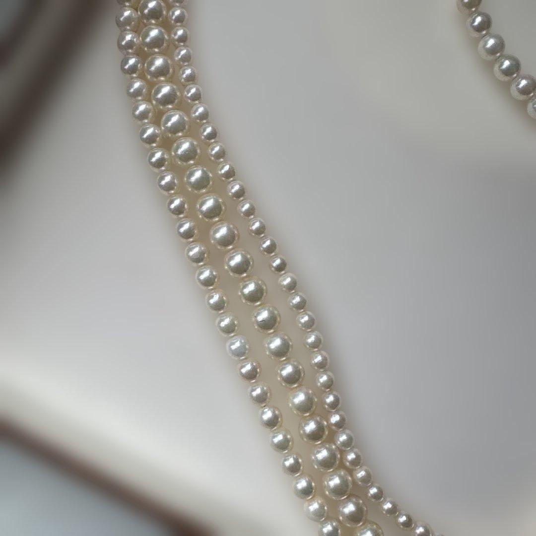 Akoya pearl necklace with three strands of varying sized white pearls, approximately 45cm long, displayed with case