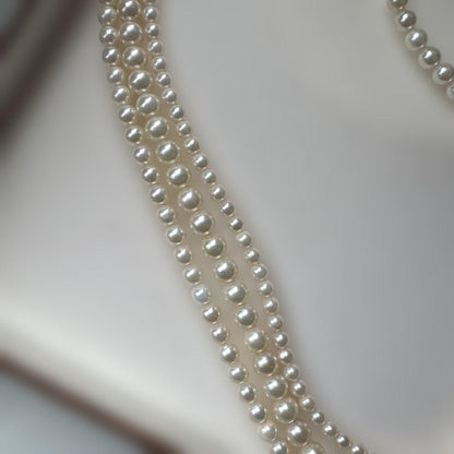 Akoya pearl necklace with three strands of varying sized white pearls, approximately 45cm long, displayed with case