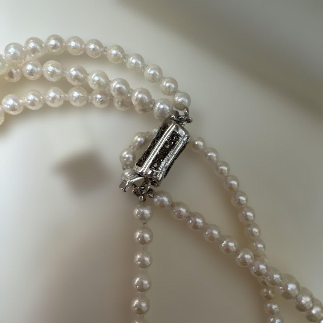Akoya pearl necklace with three strands of varying sized white pearls, approximately 45cm long, displayed with case