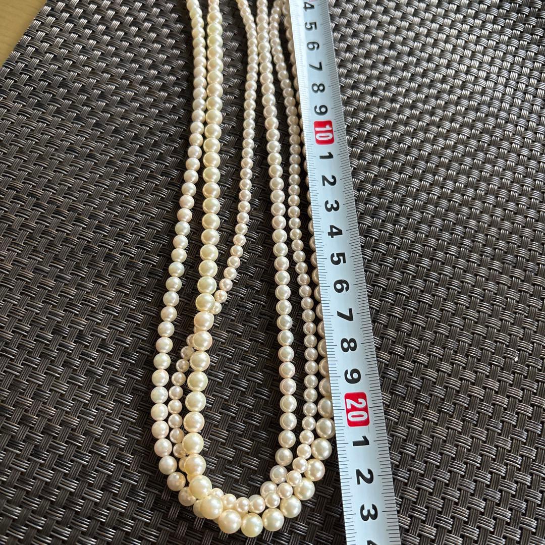 Akoya pearl necklace with three strands of varying sized white pearls, approximately 45cm long, displayed with case
