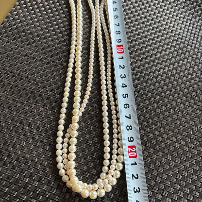 Akoya pearl necklace with three strands of varying sized white pearls, approximately 45cm long, displayed with case