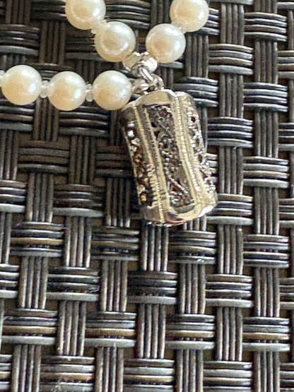 Akoya pearl necklace with three strands of varying sized white pearls, approximately 45cm long, displayed with case