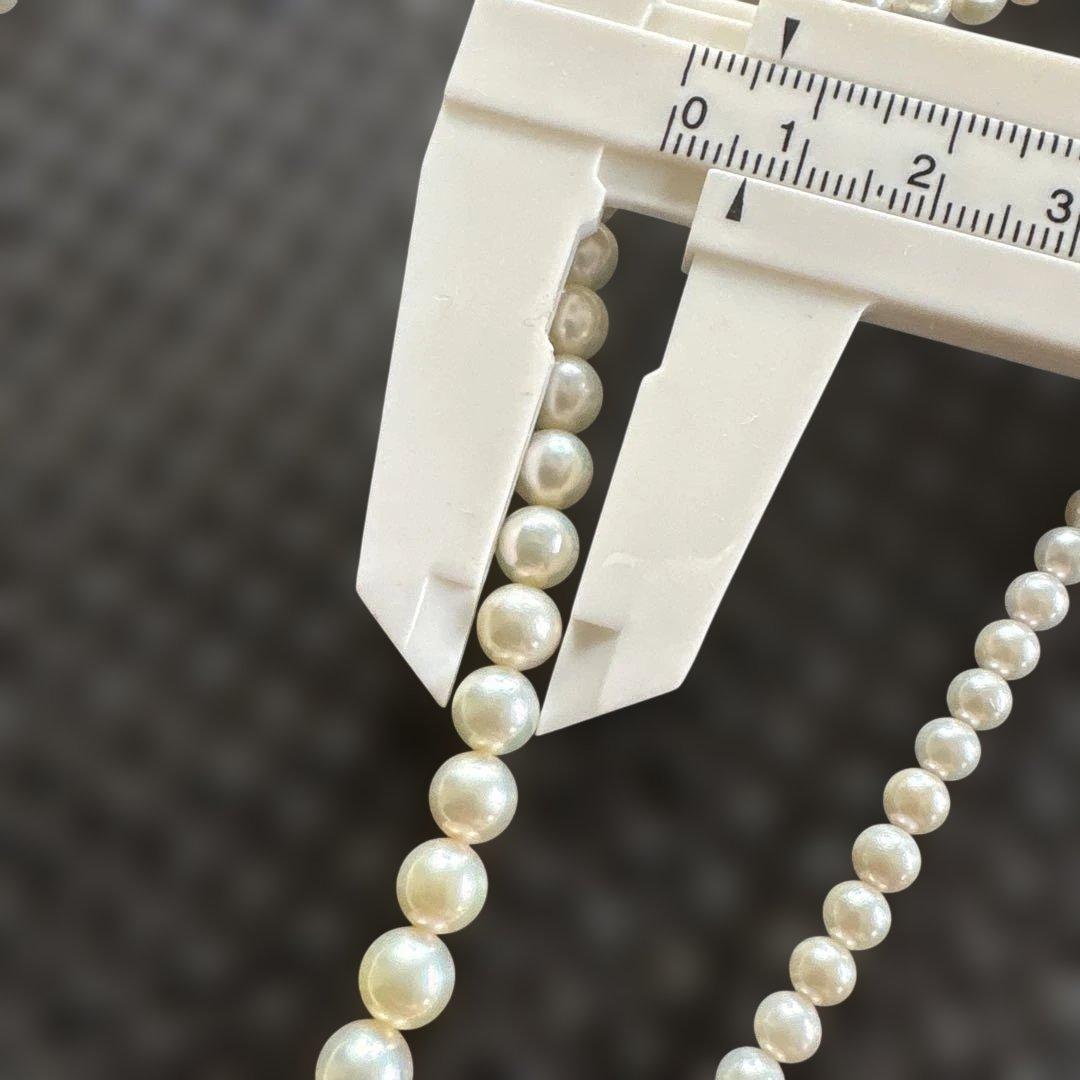 Akoya pearl necklace with three strands of varying sized white pearls, approximately 45cm long, displayed with case