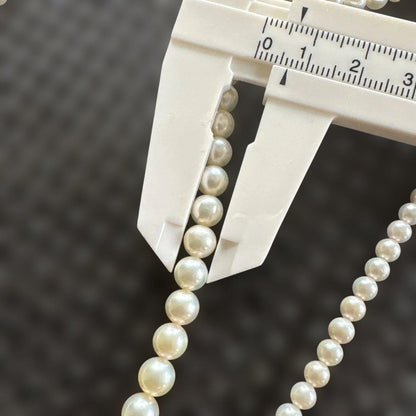 Akoya pearl necklace with three strands of varying sized white pearls, approximately 45cm long, displayed with case