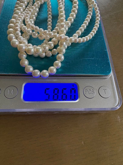 Akoya pearl necklace with three strands of varying sized white pearls, approximately 45cm long, displayed with case
