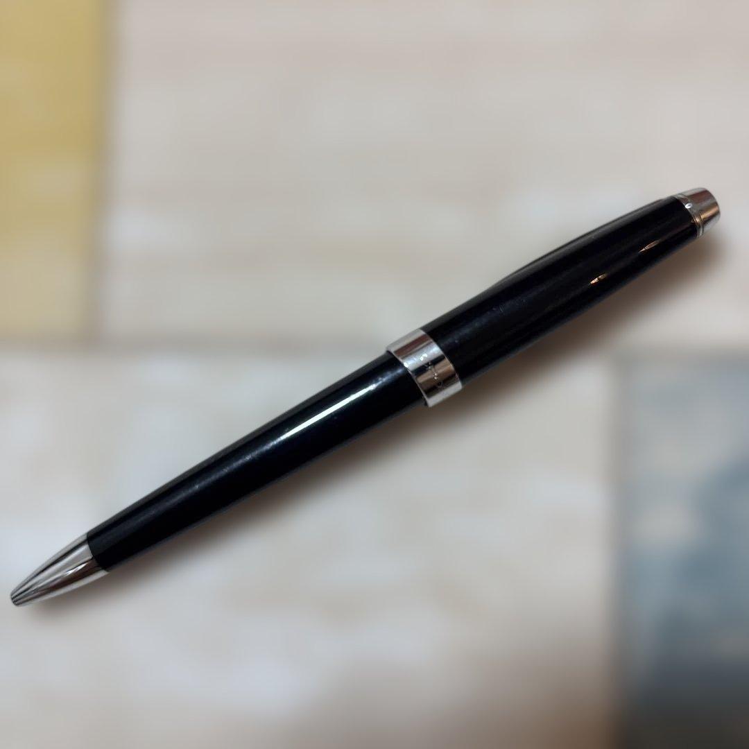 CROSS ballpoint pen with glossy black body and silver accents shown on white background