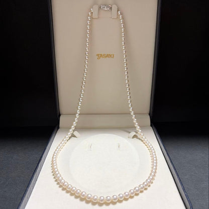 Tasaki Akoya pearl long necklace with 6.5mm genuine pearls and high luster on a white background