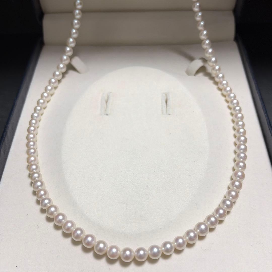 Tasaki Akoya pearl long necklace with 6.5mm genuine pearls and high luster on a white background