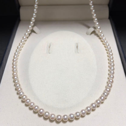 Tasaki Akoya pearl long necklace with 6.5mm genuine pearls and high luster on a white background