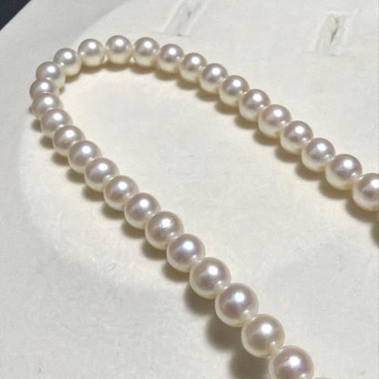 Tasaki Akoya pearl long necklace with 6.5mm genuine pearls and high luster on a white background