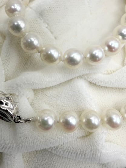 Hon-Pearl Akoya pearl necklace with 7mm white round beads displayed on a black background