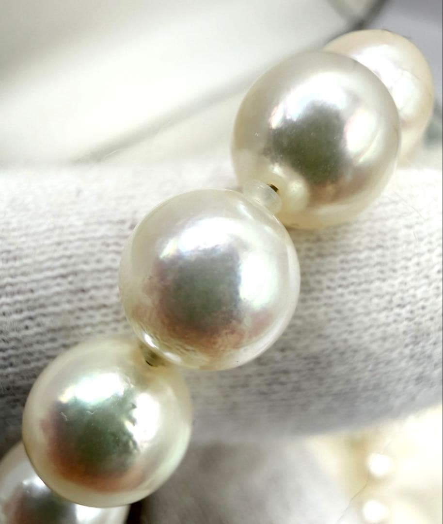Hon-Pearl Akoya pearl necklace with 7mm white round beads displayed on a black background