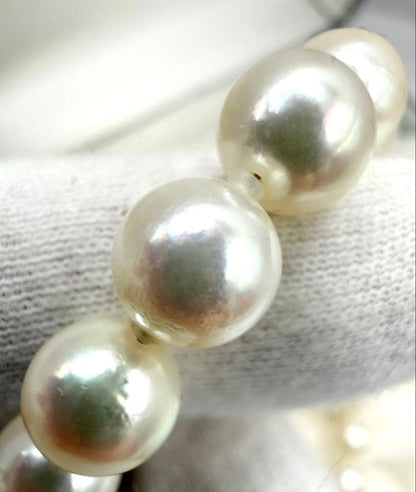 Hon-Pearl Akoya pearl necklace with 7mm white round beads displayed on a black background