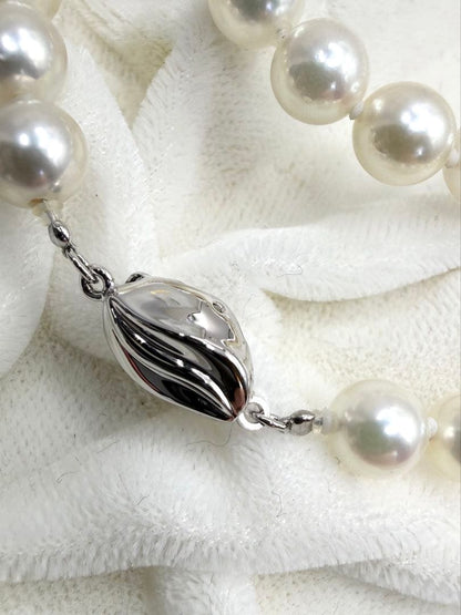 Hon-Pearl Akoya pearl necklace with 7mm white round beads displayed on a black background