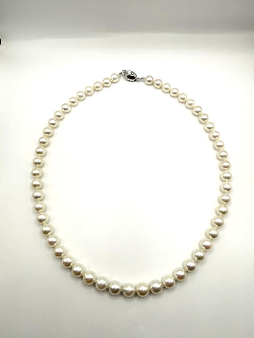 Hon-Pearl Akoya pearl necklace with 7mm white round beads displayed on a black background
