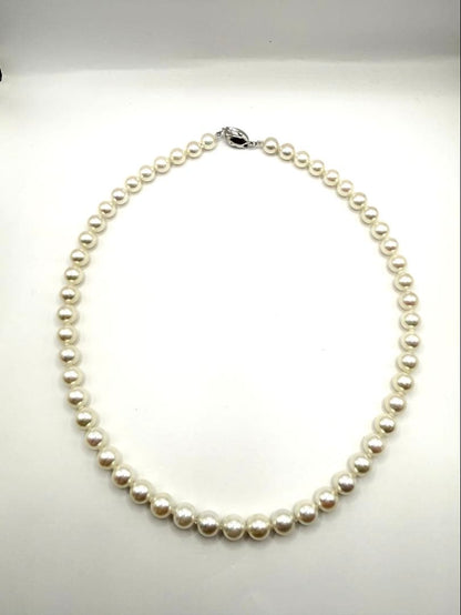 Hon-Pearl Akoya pearl necklace with 7mm white round beads displayed on a black background