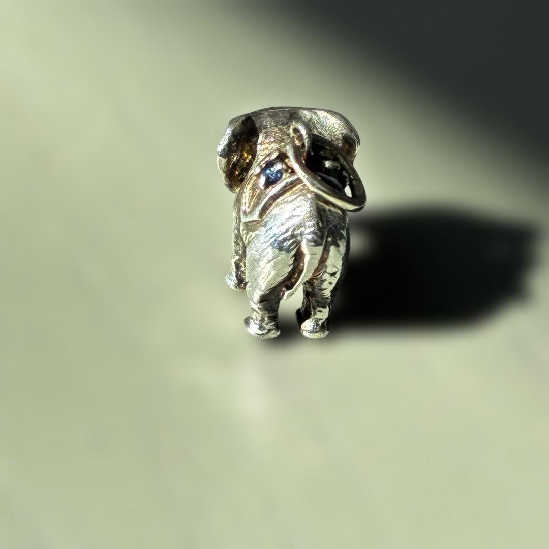 Agete Elephant Pendant Top with emerald and sapphire side stones showing tarnish and black spots