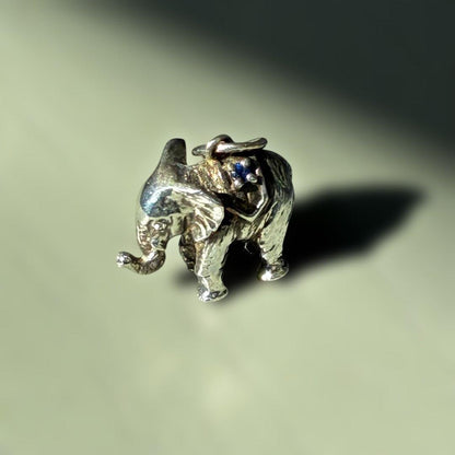 Agete Elephant Pendant Top with emerald and sapphire side stones showing tarnish and black spots