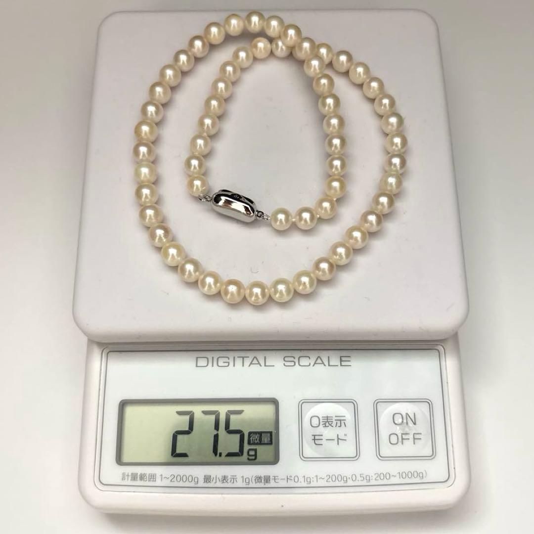 Newly polished white Akoya pearl necklace with 7mm pearls, 42cm length, laid flat