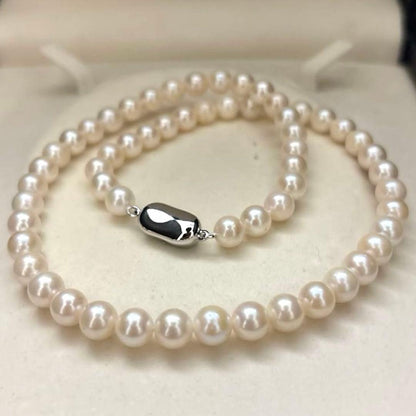Newly polished white Akoya pearl necklace with 7mm pearls, 42cm length, laid flat